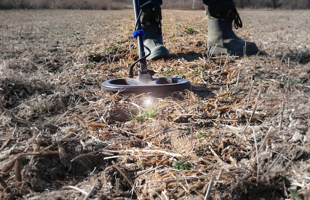 Photo searching for a bomb or mine with a metal detector