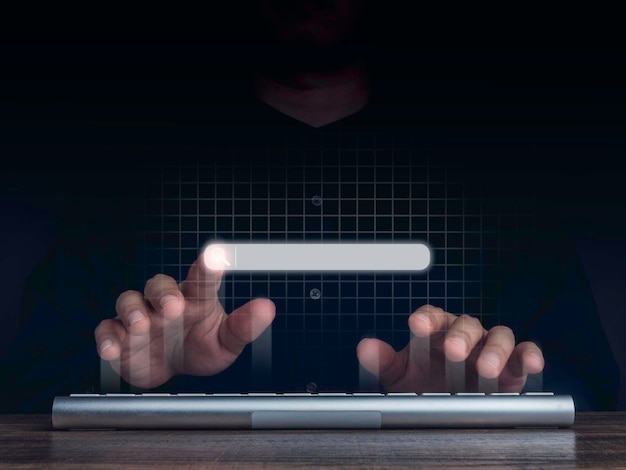 searching icon on search engine bar pointing by man's finger while using computer keyboard with network background. blank search tab. searching browsing internet data information networking concept.