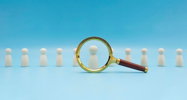 Searching for talent or looking for employee concept using magnifying glass and wooden people