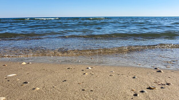 Seascape. Azure color of water, waves foaming on the shore.