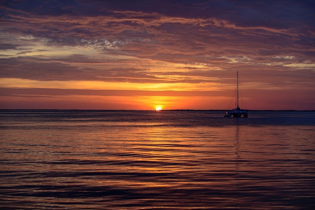 Seascape boat on sea sailboats at sunset ocean yacht sailing along water