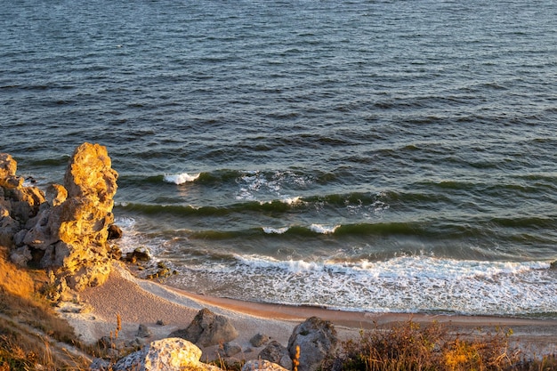 Seascape rocky seashore with a foamy wave view from the mountain travel and tourism