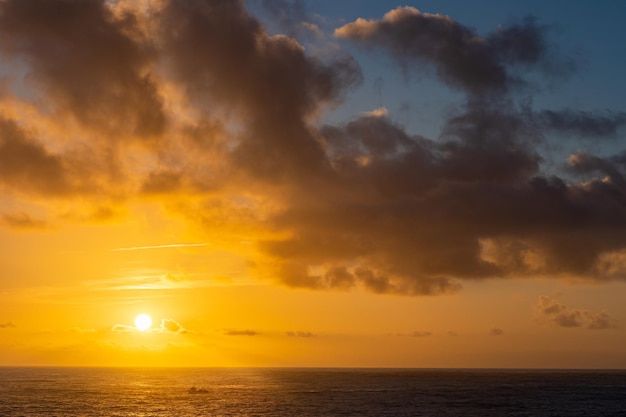 Seascape at sunset yellow sun is setting down on the horizon