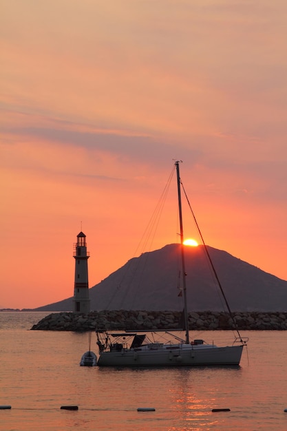 Seascape at sunshine Lighthouse and sailings on the coast Seaside town of Turgutreis