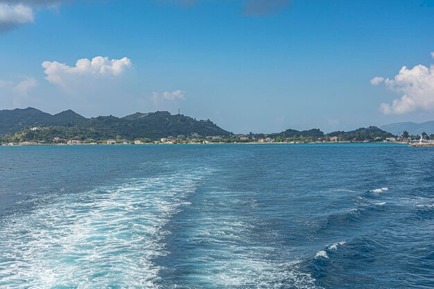 Seascape Trail on the sea from the boat on the background of the coastline