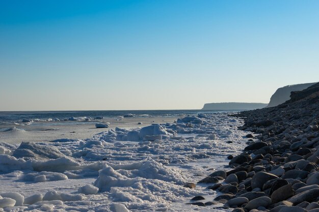 Seascape with coastline in ice and snow