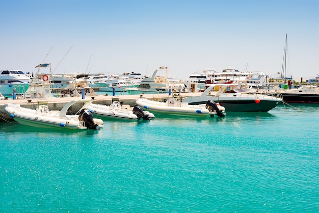 Seascape with parking and anchored boats and ships.