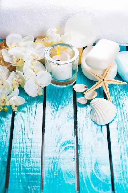 Seashell and flowers on blue wooden background. travel concept