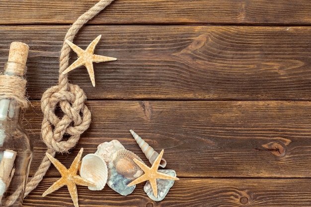 Seashells border on wood background