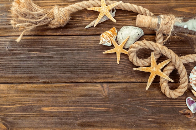 Seashells border on wood marine background