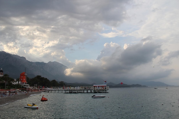 Seashore with clear water with hills and pontoon