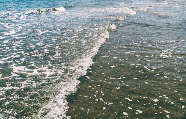 Seashore with surf, small waves