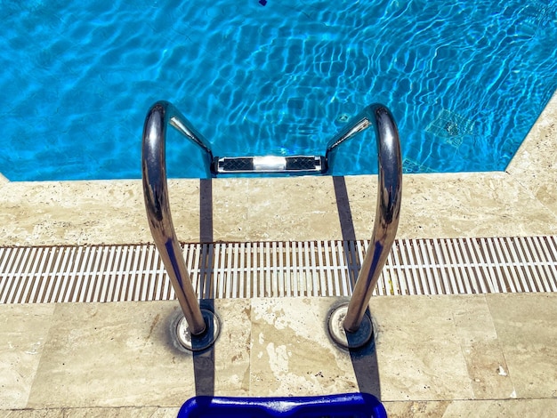 Seaside vacation by the pool deep pool with clear blue water with bleach inside metal ladder