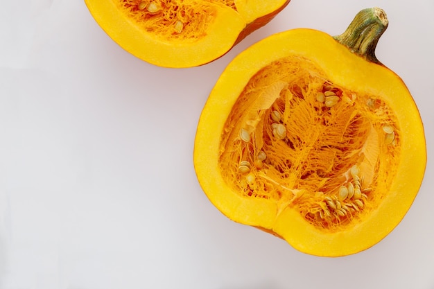 Seasonal cut pumpkin isolated on white background. Top view.