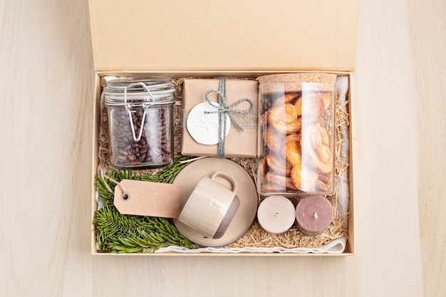 Seasonal gift box with coffee, cookies, candles and cup