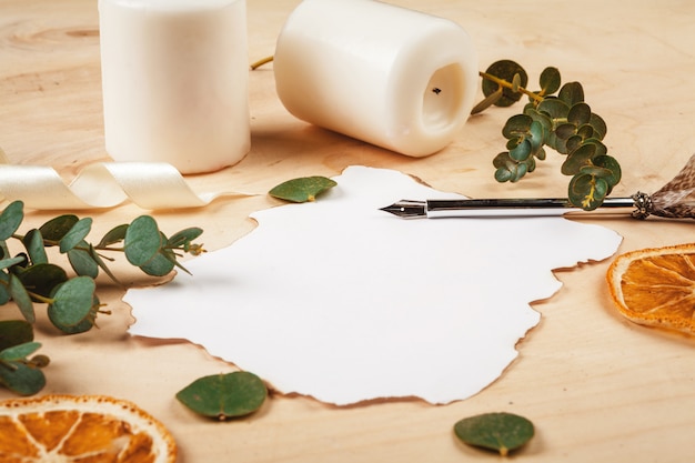 seasonal letter with a vintage feather quill pen on wooden background 
