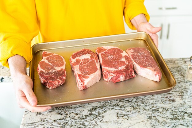 Seasoned rib eye steak ready for grilling