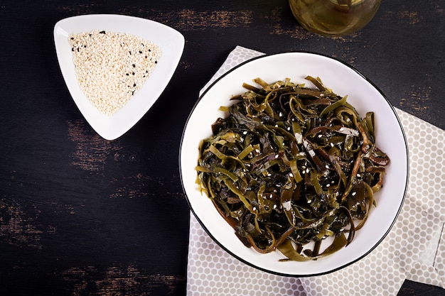 Seasoned seaweed salad and fresh herbs. Top view. 