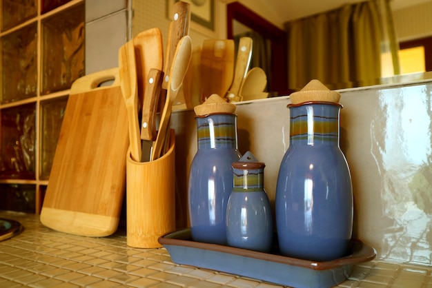 Seasoning bottles and wooden utensils on the kitchen counter