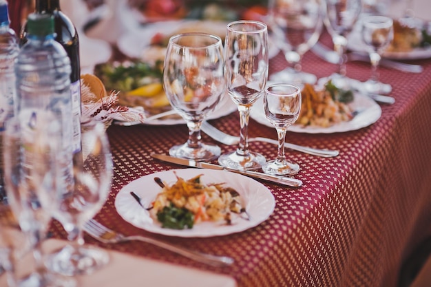 A seat at the festive table with laid out appliances and salads 2350