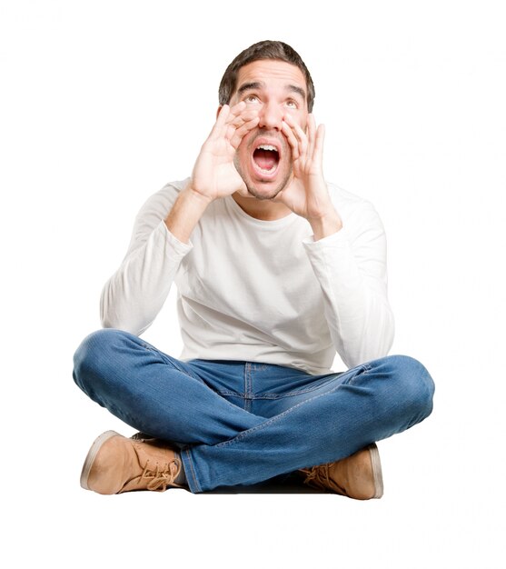 Seated young man shouting