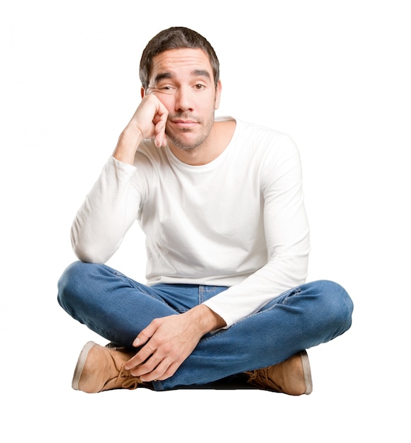 Seated young man with a gesture of depression