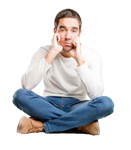 Seated young man with a gesture of depression