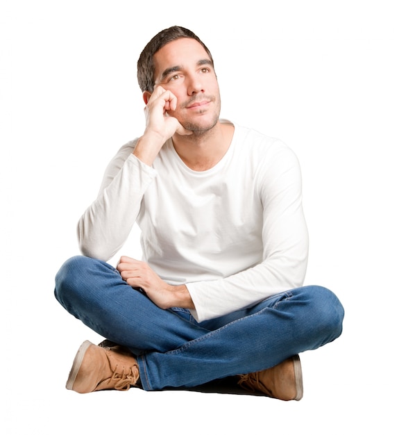 Seated young man wondering