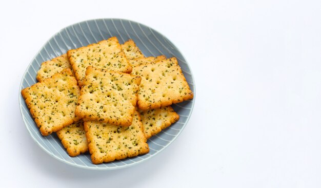 Seaweed crackers in plate on white background.