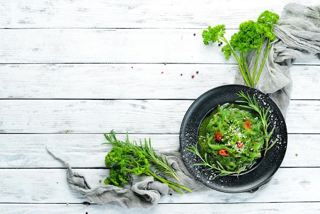 Seaweed salad on a black stone plate Chinese cuisine Top view Free copy space