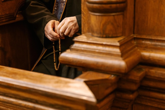 the secret of confession in the Catholic church Photo of the hands of the priest confessing in the confessional