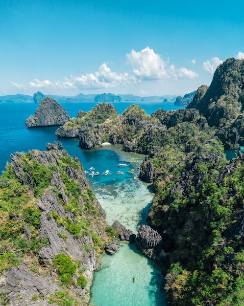 Secret lagoon in El nido. couple enjoying time in the crystal transparent water and kayaking. Concept about traveling and nature