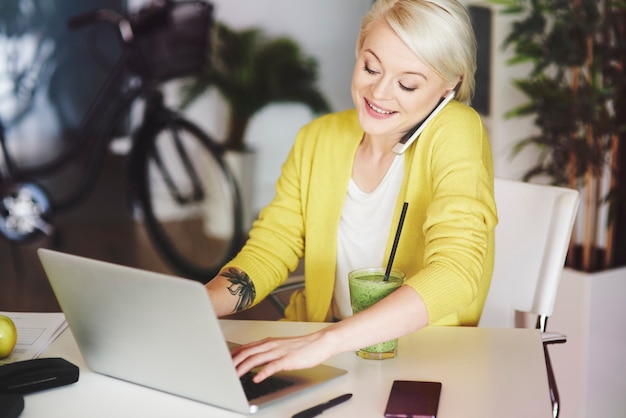 Secretaresse is aan het telefoneren met klanten en aan het typen