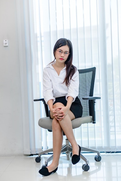 Secretary beautiful girls sit on the chair in the office of the company