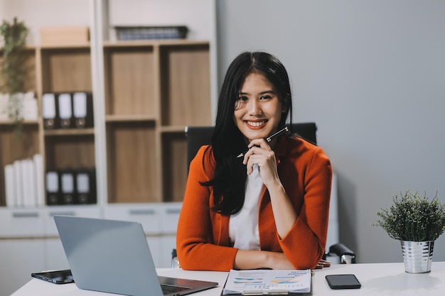 secretary concept female secretary sitting on her desk and working with happiness in office
