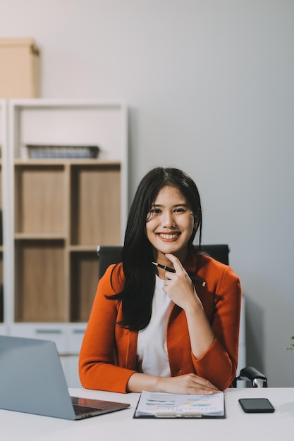secretary concept female secretary sitting on her desk and working with happiness in office