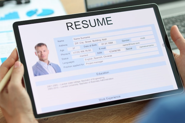 Secretary examines electronic form of man resume job search and resume writing concept