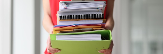 Photo secretary in red blouse holds stack of folders with archive documents in hands woman takes