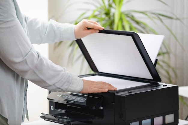 Secretary woman making a photocopy of important documents Office manager using printer scanner or laser copy machine