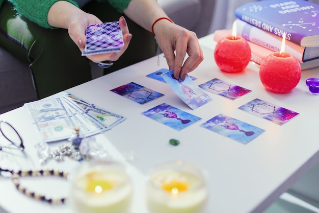 secrets of future. close up of magic tarot cards being on the table while looking into the future
