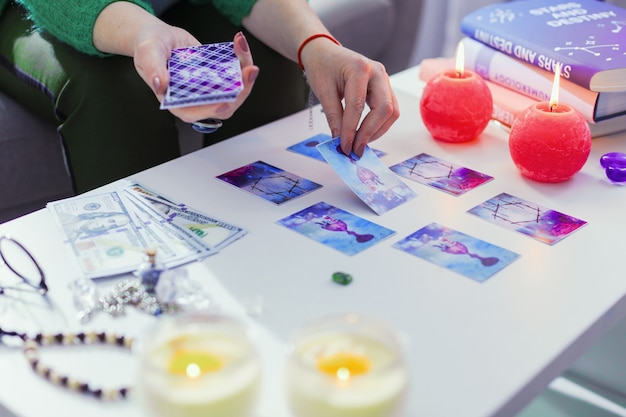 Secrets of future. Close up of magic tarot cards being on the table while looking into the future