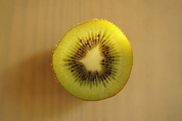 Section of kiwi on wooden background