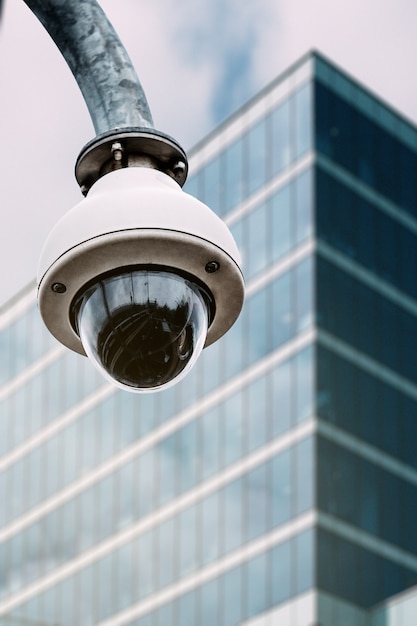 Security camera with a glass building on the background