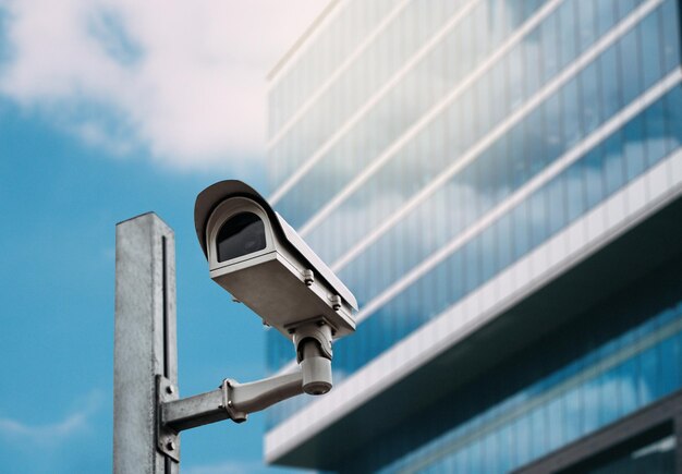 Security camera with a glass building on the background