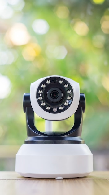 Photo security camera on a wooden table.