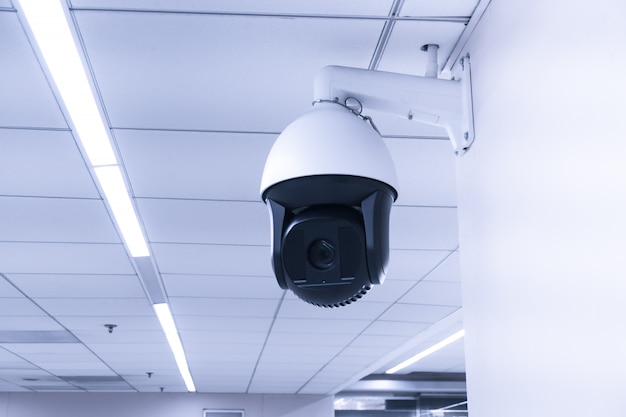 Security CCTV camera or surveillance system in building. Closed-circuit television. Modern CCTV camera on a wall.