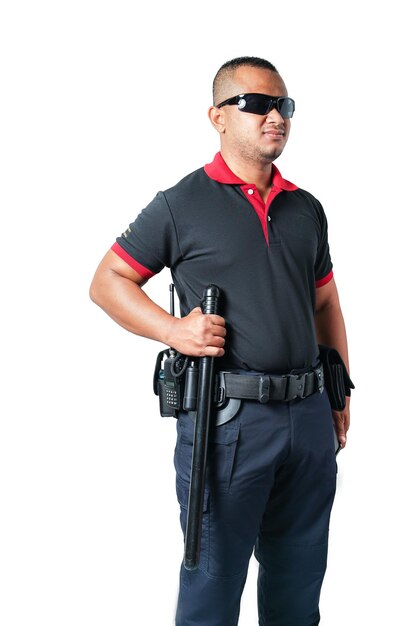 A security guard dressed in black, wearing black goggles, stands 45 degrees to the side, with a strong stand and rubber batons. on a white background isolated, cut out. Security concept