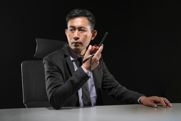 Security guard using portable radio transmitter in control room