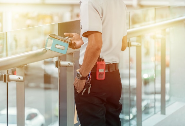 security guard using technology outside.