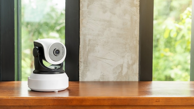 The security IP camera on a wooden table.